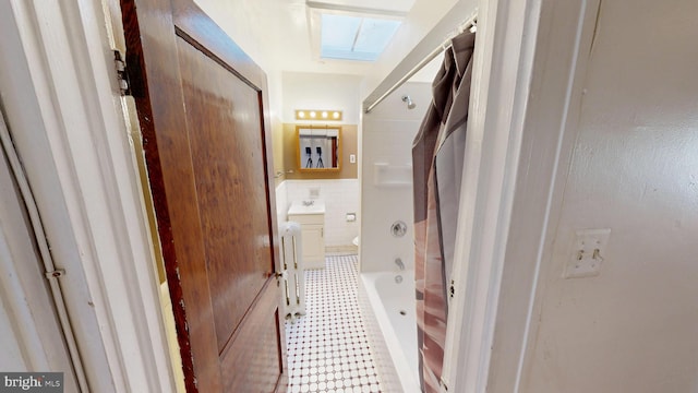 interior space featuring toilet, shower / washtub combination, vanity, and tile patterned floors