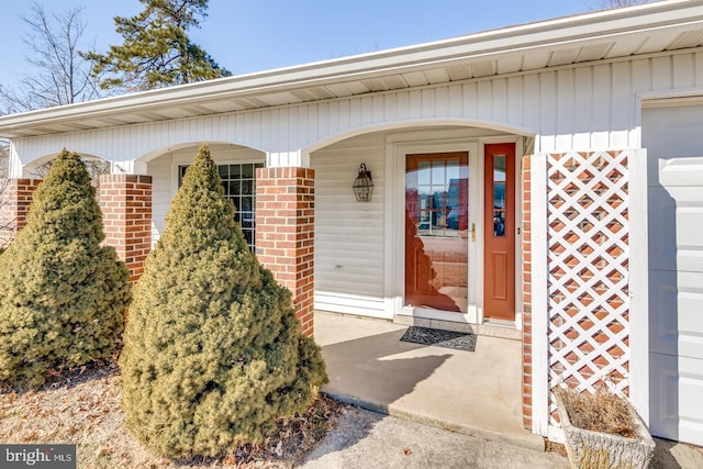 entrance to property featuring brick siding