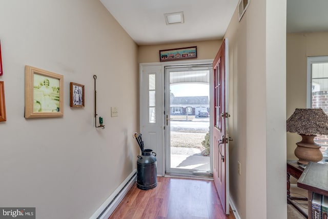 entryway with visible vents, baseboards, and wood finished floors