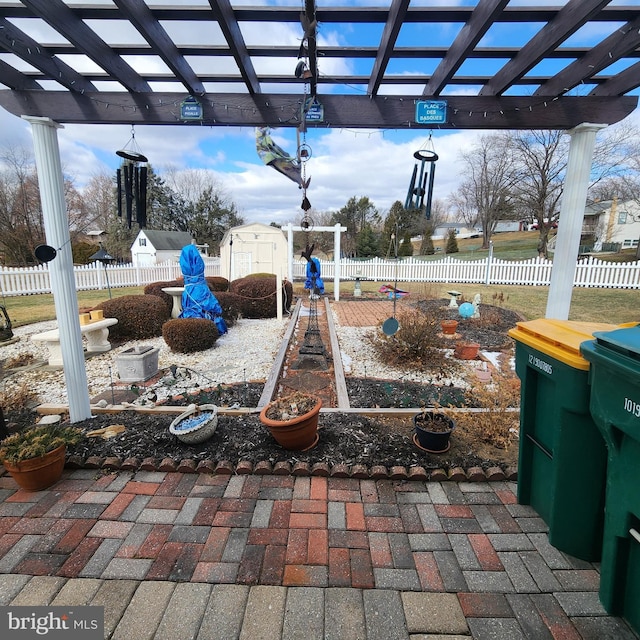 view of patio featuring a shed, an outdoor structure, fence, and a pergola