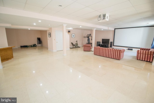 home theater room featuring decorative columns and a paneled ceiling