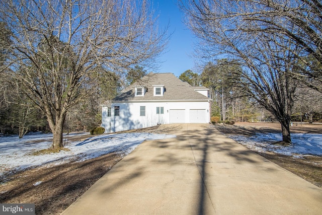 view of snow covered exterior with driveway