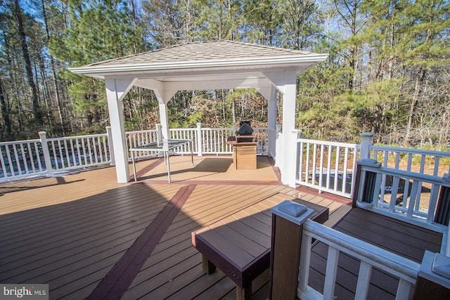 wooden terrace featuring a gazebo