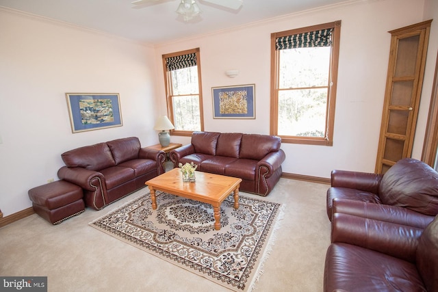 carpeted living room featuring baseboards, ornamental molding, a wealth of natural light, and a ceiling fan