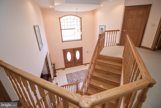 stairway featuring a chandelier and baseboards