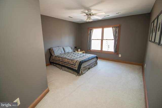 bedroom featuring baseboards, a ceiling fan, and light colored carpet