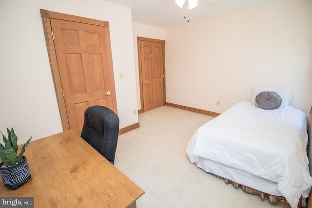 bedroom with light carpet and baseboards