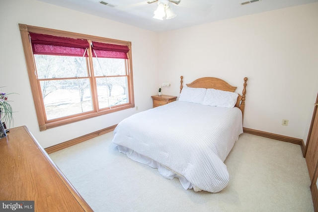 bedroom with carpet floors, visible vents, and baseboards