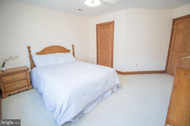 bedroom with light carpet, visible vents, baseboards, and a ceiling fan