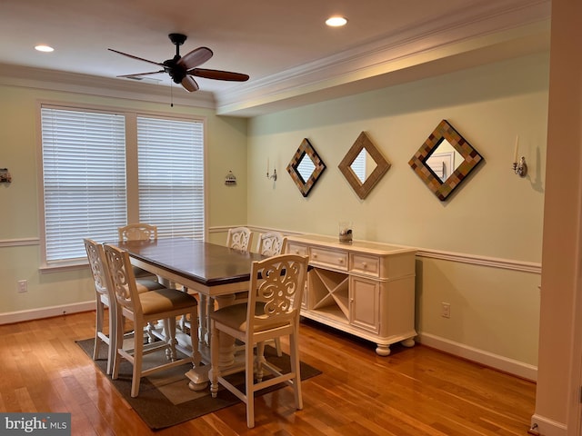 dining room featuring recessed lighting, baseboards, crown molding, and light wood finished floors