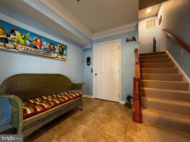 interior space featuring stairway, baseboards, visible vents, and crown molding