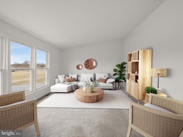 carpeted living area with lofted ceiling