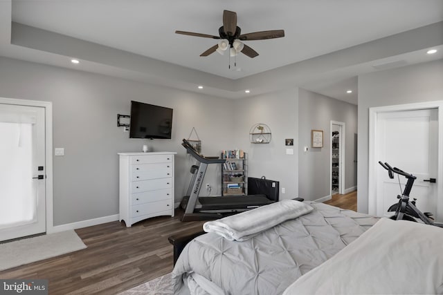 bedroom with baseboards, wood finished floors, and recessed lighting