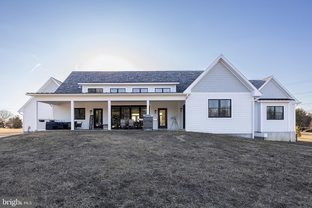 modern inspired farmhouse with a patio area and a front yard