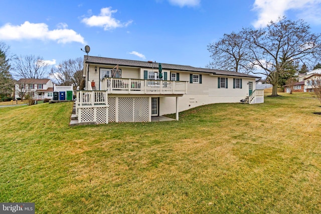 rear view of house featuring a yard and a deck