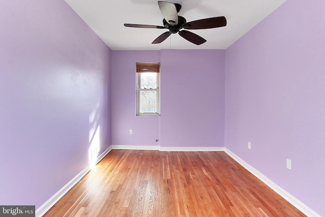 unfurnished room with baseboards, light wood-type flooring, and ceiling fan