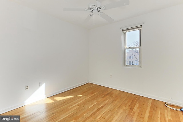 empty room with baseboards, light wood-type flooring, and a ceiling fan