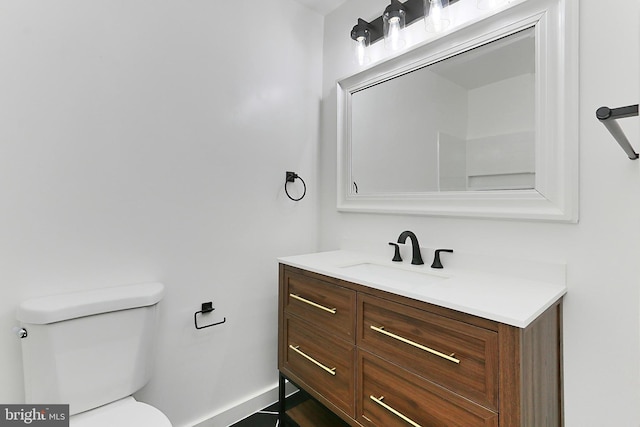 bathroom with toilet and vanity