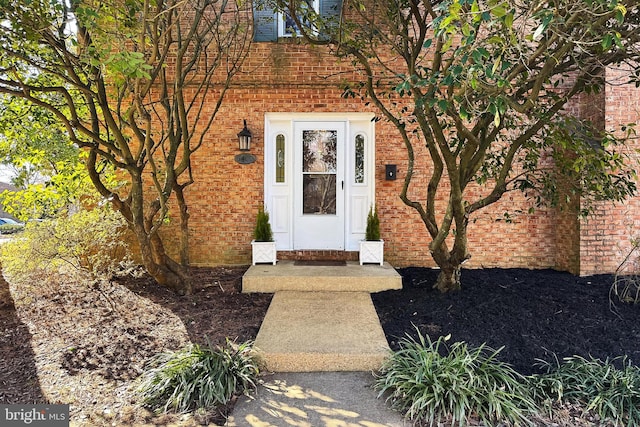 property entrance with brick siding