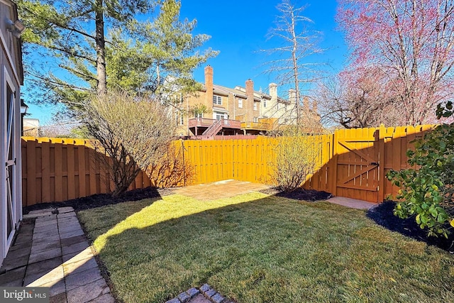 view of yard with a gate and a fenced backyard