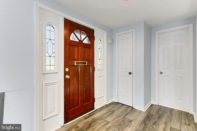 entrance foyer featuring dark wood-style floors and baseboards