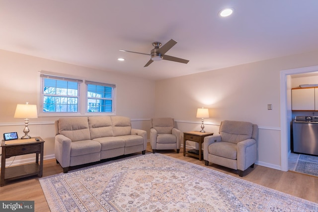 living room with washer / clothes dryer, light wood-type flooring, and recessed lighting