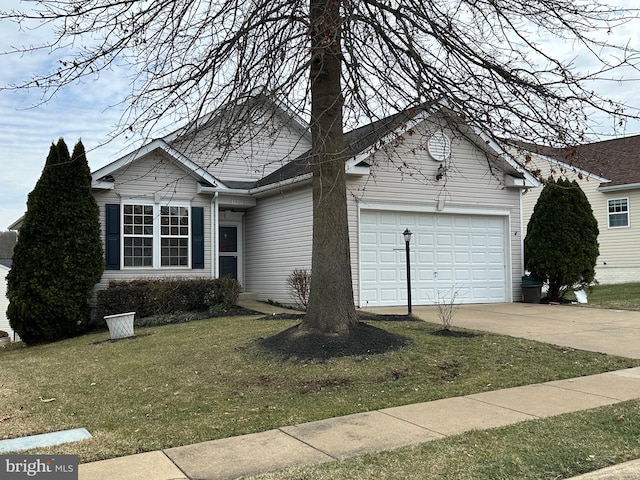 single story home featuring an attached garage, driveway, and a front lawn