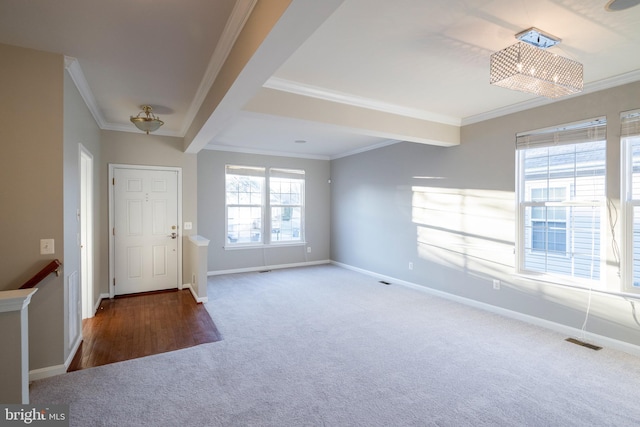 foyer with carpet floors, visible vents, crown molding, and baseboards