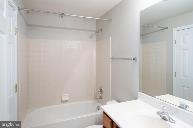 full bathroom with bathing tub / shower combination, toilet, and vanity