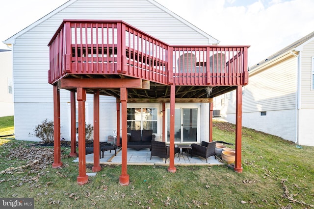 rear view of house featuring a yard, a patio, and a wooden deck