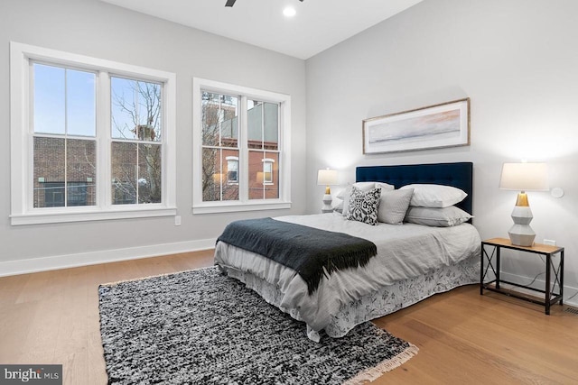 bedroom featuring recessed lighting, baseboards, and wood finished floors