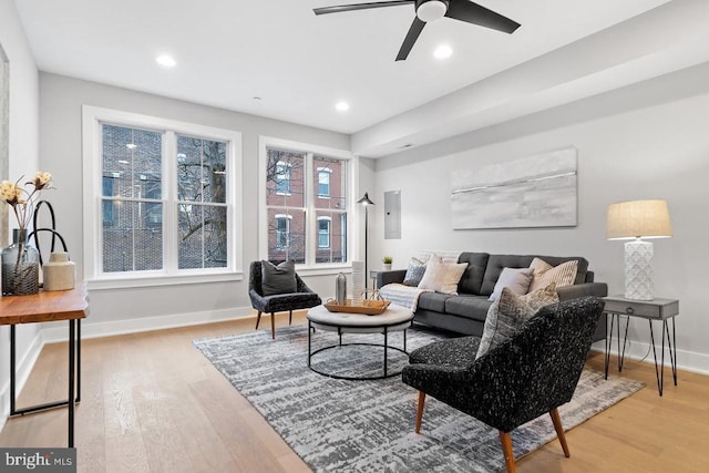 living room featuring baseboards, wood finished floors, and recessed lighting