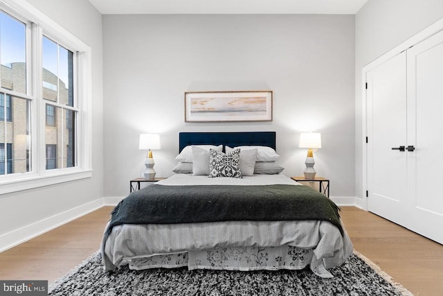 bedroom featuring baseboards and wood finished floors