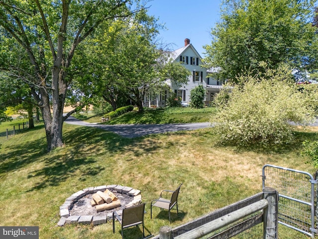 view of yard with a fire pit and fence