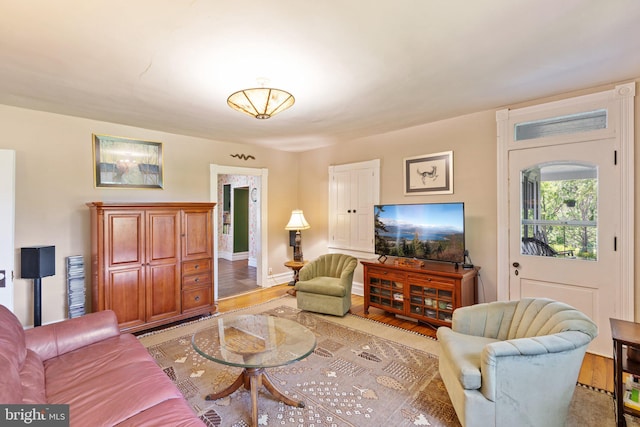 living room with light wood-style flooring and baseboards