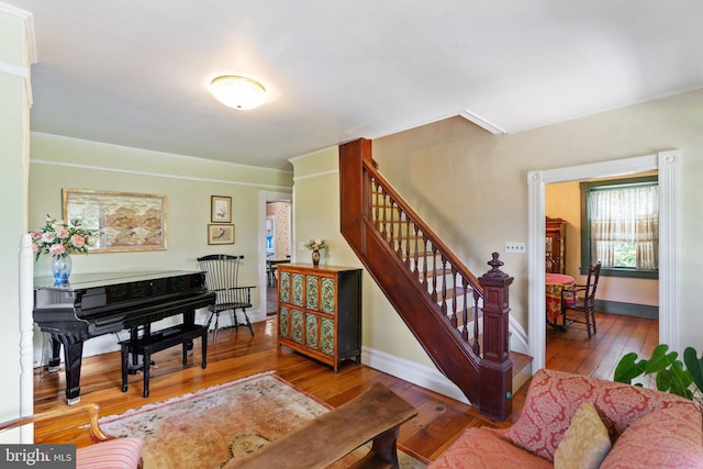 interior space featuring stairway, wood finished floors, and baseboards