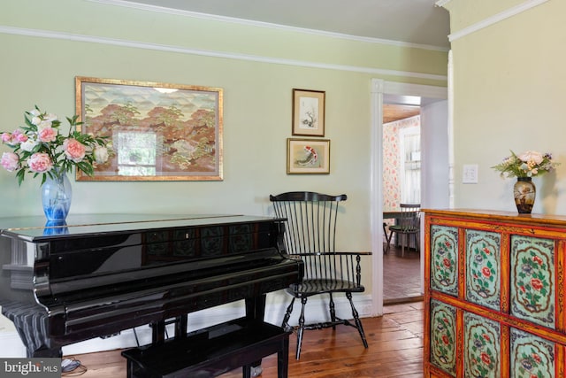 living area featuring crown molding and wood finished floors