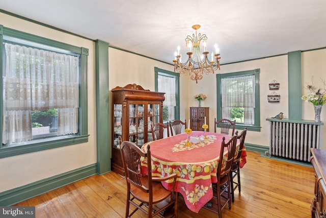 dining area featuring light wood-style floors, a chandelier, and a wealth of natural light