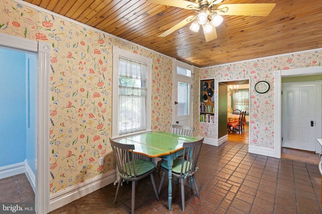 dining room featuring wooden ceiling, baseboards, and wallpapered walls