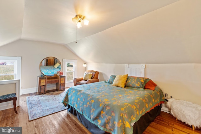 bedroom featuring vaulted ceiling and wood finished floors