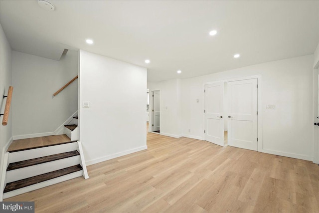 interior space with light wood-type flooring, stairs, and recessed lighting