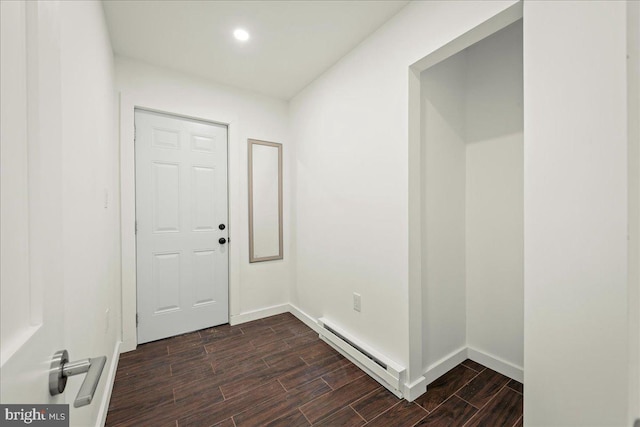 interior space featuring wood finish floors, baseboards, baseboard heating, and recessed lighting