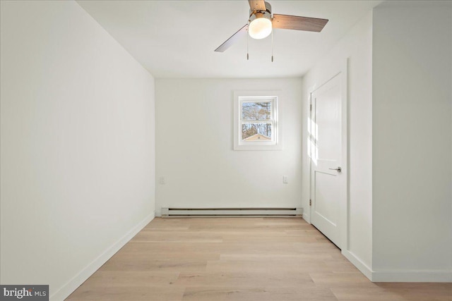 empty room featuring light wood-type flooring, baseboards, a baseboard heating unit, and ceiling fan