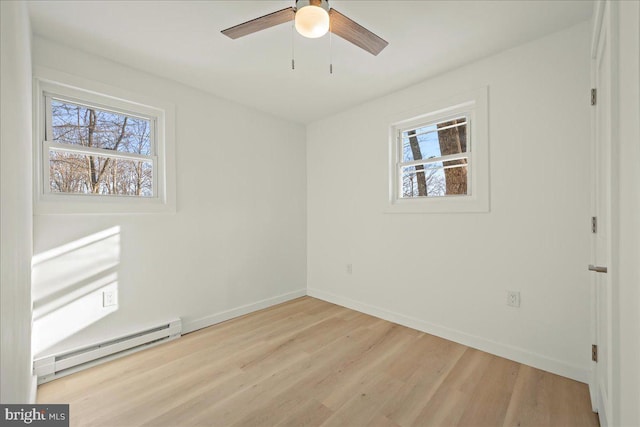 unfurnished bedroom featuring a ceiling fan, baseboards, light wood finished floors, and baseboard heating