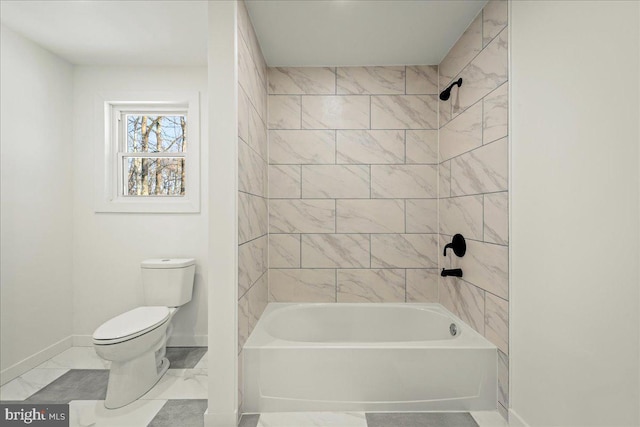 full bathroom with marble finish floor, baseboards, toilet, and shower / tub combination