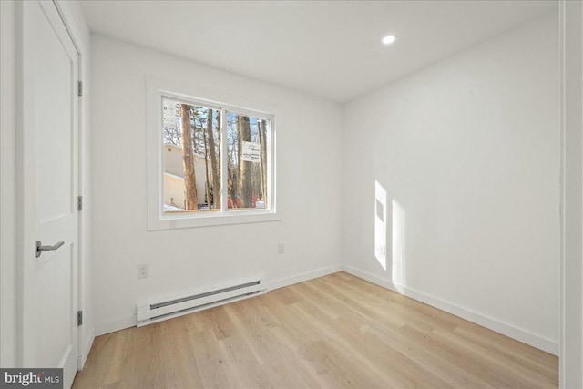 unfurnished bedroom featuring recessed lighting, baseboards, light wood finished floors, and baseboard heating