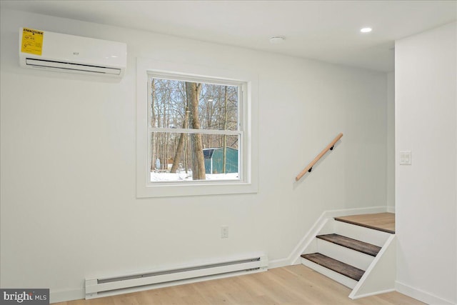 stairway with baseboards, wood finished floors, a wall mounted air conditioner, a baseboard heating unit, and recessed lighting