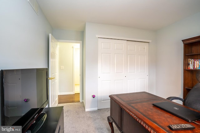 home office with light carpet, visible vents, and baseboards