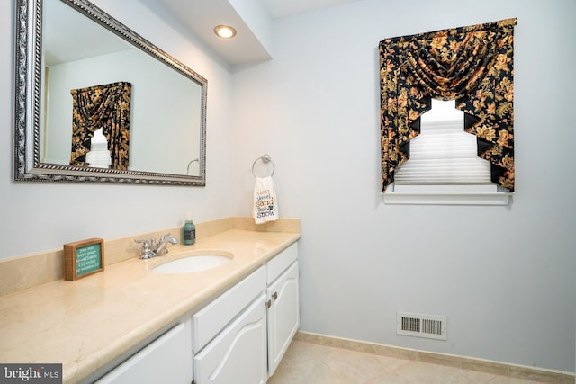 bathroom featuring tile patterned flooring, visible vents, vanity, and baseboards