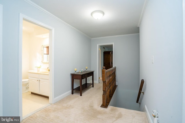 hallway with light carpet, ornamental molding, an upstairs landing, and baseboards